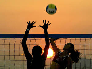 Beach Volleyball In Motion Blur At Sunset Wallpaper
