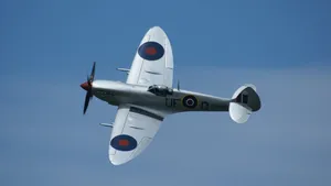 Beautiful British Spitfire Warplane Soaring In The Sky Wallpaper