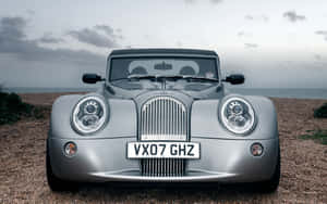 Beautiful Morgan Sports Car Parked By The Picturesque Coast Wallpaper