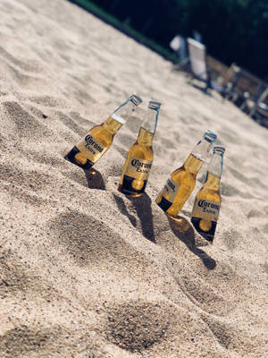 Beer Bottles In Sand Wallpaper