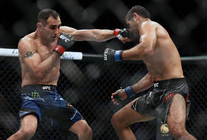 Beneil Dariush Dodging A Punch From Tony Ferguson In Ufc Fight Wallpaper