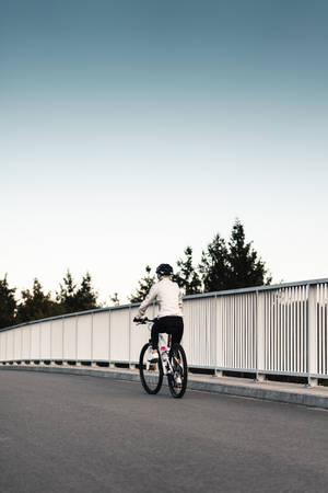 Bike Lover On A Bridge Wallpaper