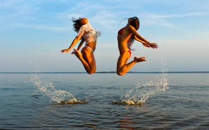 Bikini Girl Jumping On Sea Wallpaper