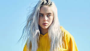 Billie Eilish Poses With A Laptop Wallpaper