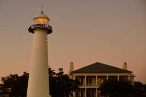 Biloxi Lighthouse In Mississippi As The Sun Sets Wallpaper