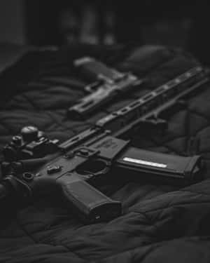 Black Gangster Rifle On Bed Wallpaper