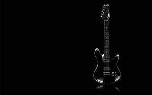 Black Guitar Against Dark Screen Wallpaper