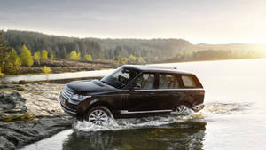 Black Land Rover In Water Wallpaper