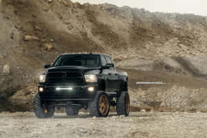 Black Lifted Truck On Dirt Field Wallpaper