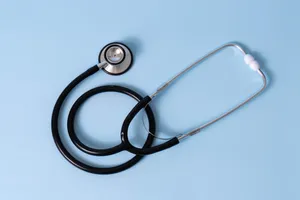 Black Stethoscope On A Blue Surface Wallpaper