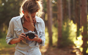 Blonde Woman Holding A Film Camera Wallpaper