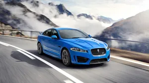 Blue Jaguar Car By Mountains Wallpaper