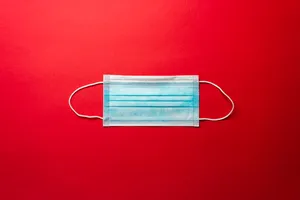 Blue Mask On Plain Red Wallpaper