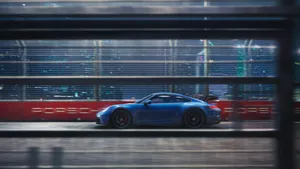Blue Porsche 911 Outside The Window Wallpaper