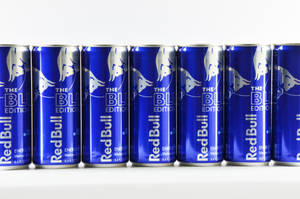 Blue Red Bull Cans Lined Up Wallpaper