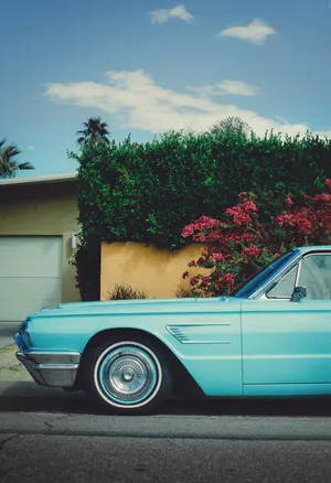 Blue Vintage Ford In Front Of Garage Wallpaper