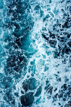 Blue Water With White Foam On The Surface Wallpaper