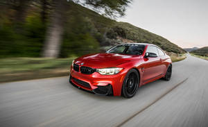 Bmw M4 Zooming On The Road Wallpaper