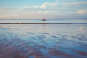 Boat Silhouette During Low Tide Wallpaper