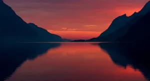 Body Of Water With Mountains Under Evening Sky Wallpaper