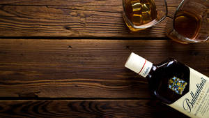 Bottle And Glasses Of Alcohol On Wooden Table Wallpaper