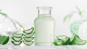 Bottle With Aloe Vera Slices Wallpaper