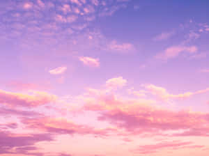 Breathtaking Blue Sky With Beautiful Gold And Pink Clouds Wallpaper