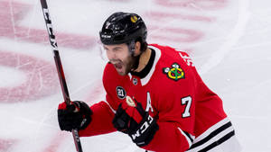 Brent Seabrook In Action On The Ice Rink Wallpaper