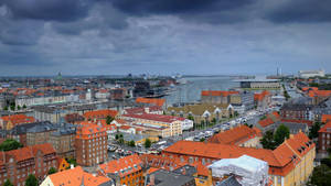 Brooding Sky Over Copenhagen Houses Wallpaper