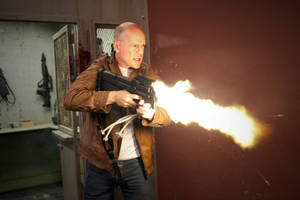 Bruce Willis In An Action-packed Scene Wallpaper