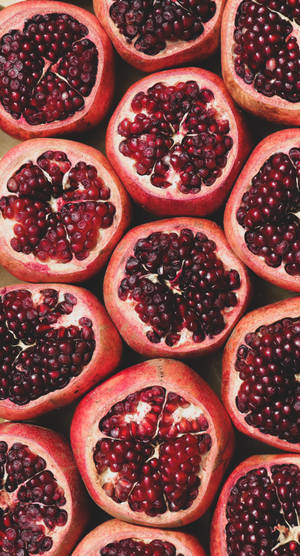 Bursting With Goodness: A Ripe Red Pomegranate Fruit. Wallpaper