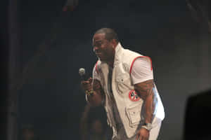 Busta Rhymes Performing Liveon Stage Wallpaper