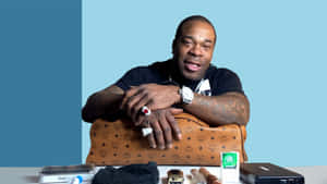Busta Rhymes Posingwith Technology Products Wallpaper