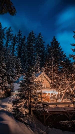 Cabin At Night With Snow Falling Wallpaper