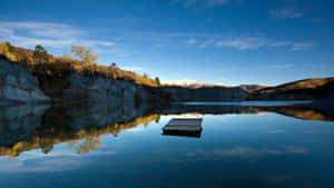 Calming Desktop Lake Surrounded By Mountain Wallpaper