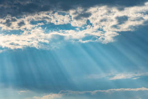 Calming Funeral Clouds With Sunlight Wallpaper