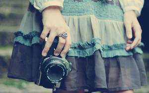 Camera Held By Woman Wallpaper