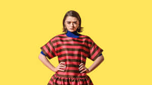 Caption: A Charismatic Maisie Williams Grasping The Attention With Her Intense Gaze. Wallpaper