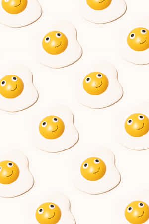 Caption: A Lively Smile Emoji Blended With Sunny Side Up Egg Wallpaper