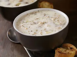 Caption: A Warm Bowl Of New England Clam Chowder With Toasted Bread Wallpaper