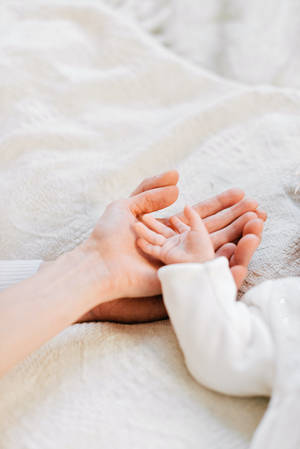 Caption: Adorable Newborn Baby Girl In White Linen Wallpaper