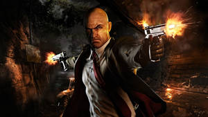 Caption: Agent 47, The Silent Assassin Treks Through A Shadowy Cave In Hitman Absolution Wallpaper