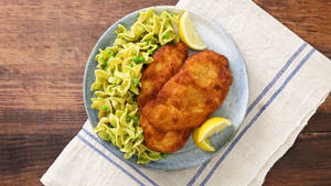 Caption: Authentic Wiener Schnitzel Served With Pasta Wallpaper