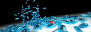 Caption: Blue And Red Medical Capsule In Descent Wallpaper