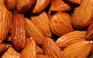 Caption: Close-up Shot Of Almond Nuts Wallpaper