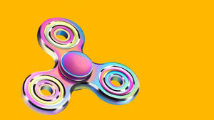 Caption: Colorful Fidget Toy On A Gradient Background Wallpaper