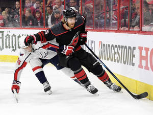 Caption: Dougie Hamilton In Action Against Andre Burakovsky Wallpaper