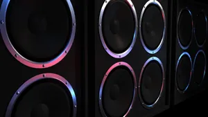 Caption: Dynamic Black Music Speakers With Colorful Anodized Basket Wallpaper