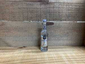 Caption: Elegant Beluga Vodka Bottle On Classic Wood Floor Wallpaper