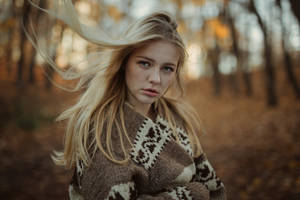 Caption: Elegant Blonde Woman Embracing Fall Fashion Wallpaper